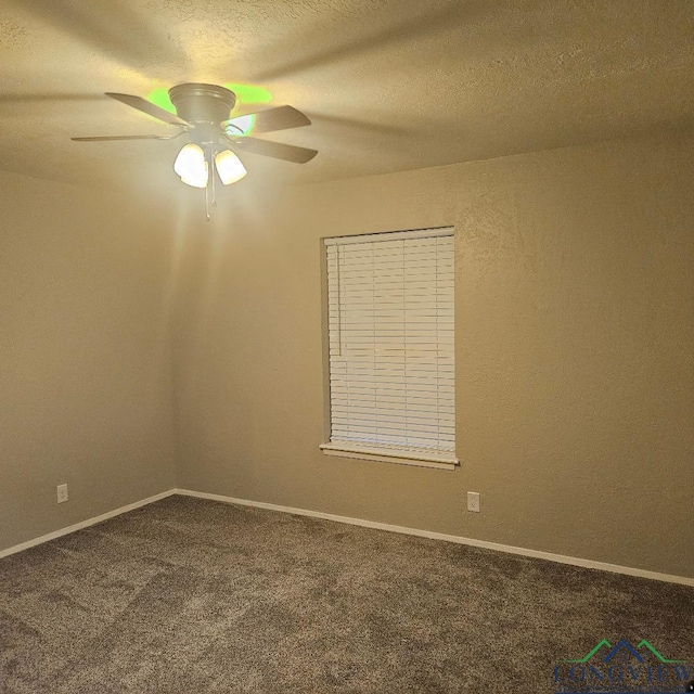 carpeted spare room with ceiling fan and a textured ceiling