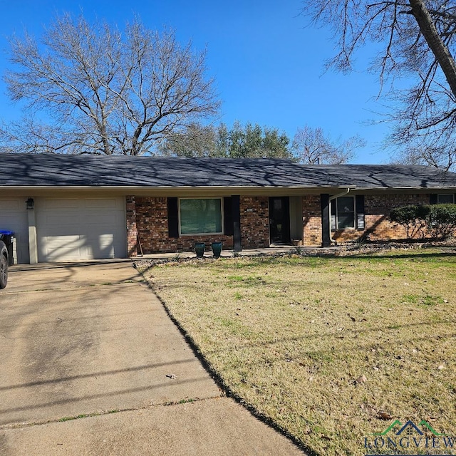 ranch-style house featuring a garage and a front yard