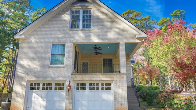 front facade with ceiling fan, a garage, and central air condition unit