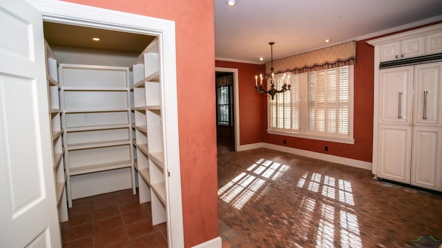 unfurnished dining area featuring a notable chandelier and ornamental molding