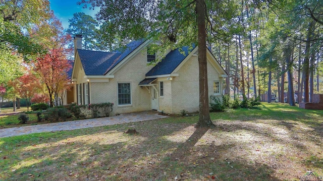 view of front of property featuring a front lawn and a patio area