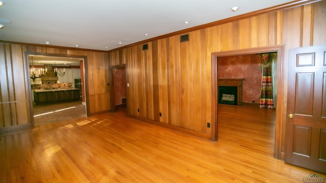 spare room with light hardwood / wood-style flooring and ornamental molding