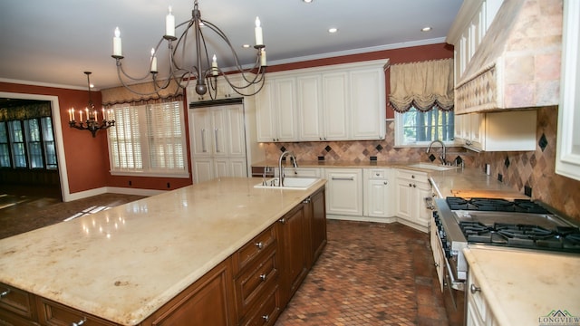 kitchen with light stone countertops, sink, a center island with sink, an inviting chandelier, and high end stainless steel range