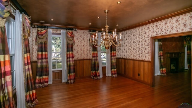 interior space featuring crown molding, dark wood-type flooring, and an inviting chandelier