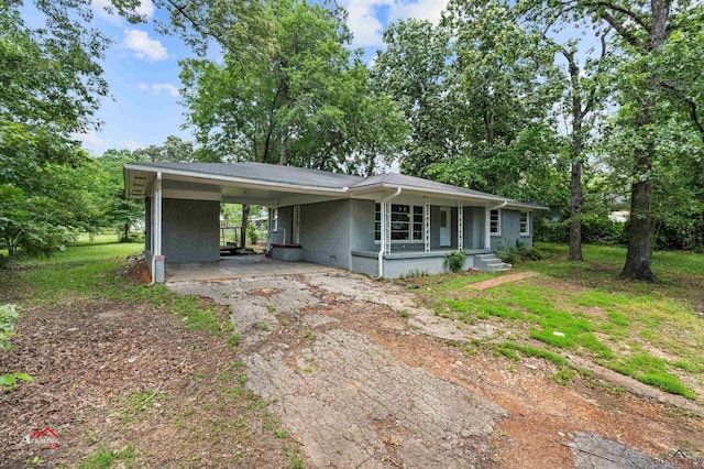 ranch-style house featuring a carport