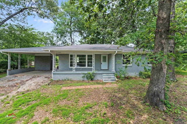 single story home with a porch and a carport