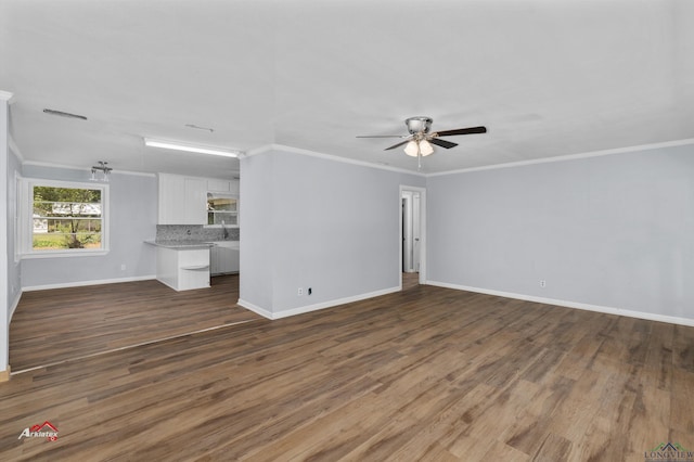 unfurnished living room with ceiling fan, dark hardwood / wood-style flooring, and ornamental molding