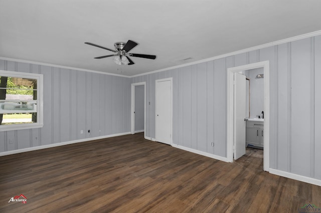 unfurnished bedroom with ensuite bathroom, crown molding, ceiling fan, and dark wood-type flooring