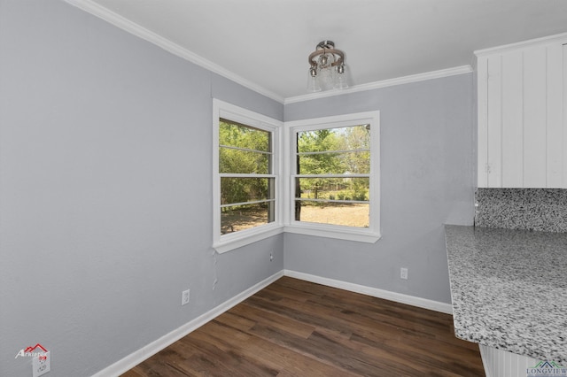 unfurnished dining area featuring dark hardwood / wood-style flooring and ornamental molding