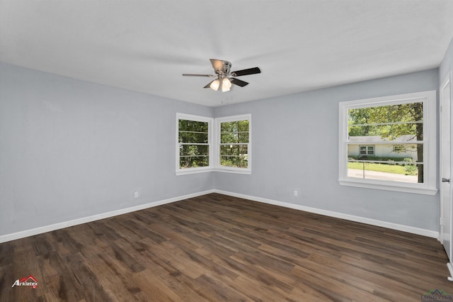 empty room featuring dark hardwood / wood-style floors, ceiling fan, and plenty of natural light