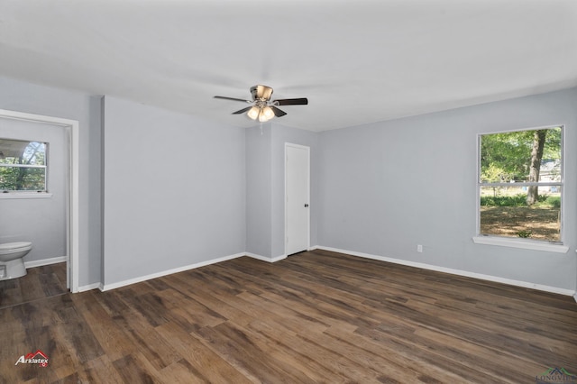 unfurnished room featuring ceiling fan, dark hardwood / wood-style flooring, and plenty of natural light