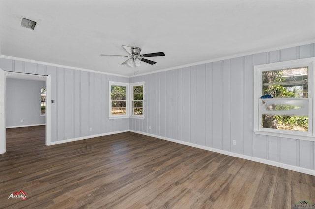 unfurnished room featuring ceiling fan, dark hardwood / wood-style floors, and ornamental molding