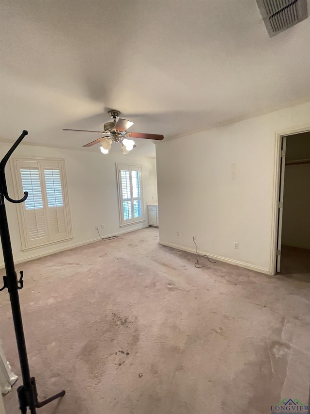 1404 Stonebriar Dr, Carthage, TX 75633 - unfurnished living room featuring ceiling fan, light colored carpet, and baseboards