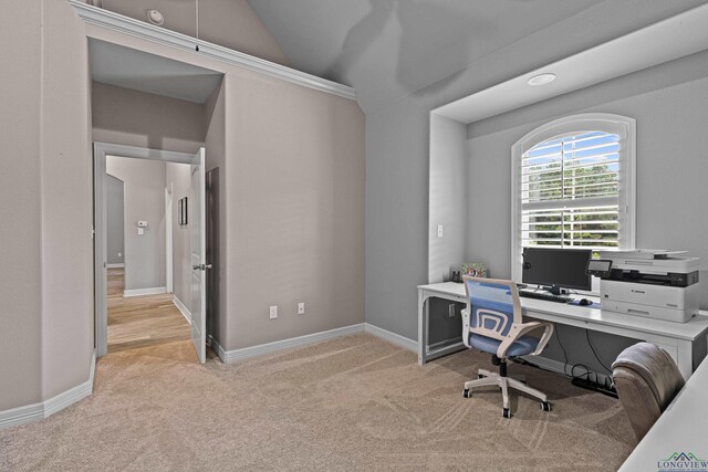 carpeted office with lofted ceiling