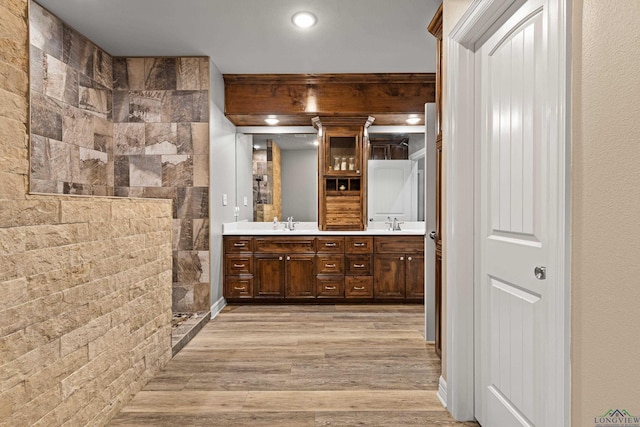 bathroom featuring a shower, vanity, and wood-type flooring