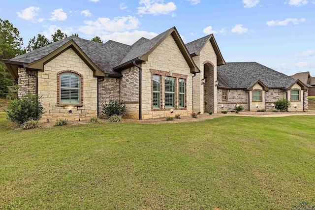 french provincial home featuring a front lawn