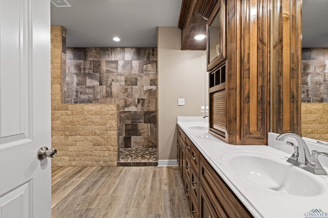 bathroom with vanity, wood-type flooring, and walk in shower