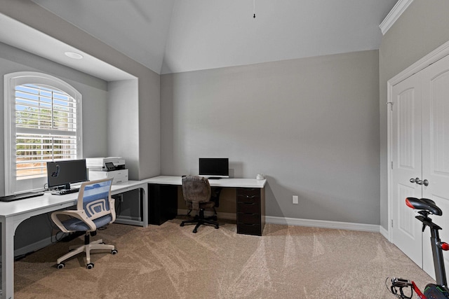 carpeted home office with crown molding and lofted ceiling