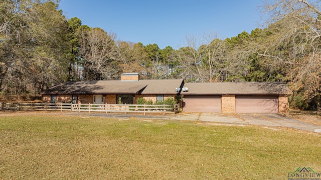 view of front of property featuring a garage and a front yard