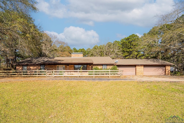 view of front facade with a garage and a front lawn