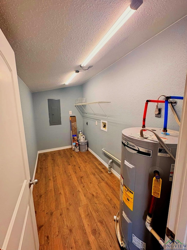 utility room with electric panel and water heater