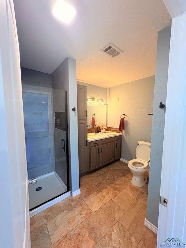 full bathroom with visible vents, toilet, a shower stall, vanity, and baseboards