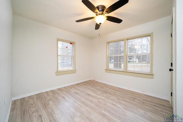 empty room with ceiling fan, light hardwood / wood-style floors, and a wealth of natural light