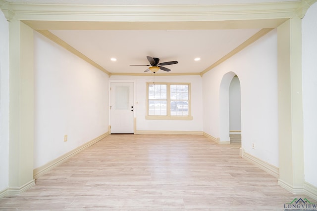 spare room featuring ceiling fan, crown molding, and light wood-type flooring