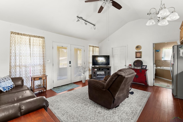 7869 Arrowwood Rd, Gilmer, TX 75644 - living room featuring lofted ceiling, a ceiling fan, dark wood finished floors, french doors, and a chandelier