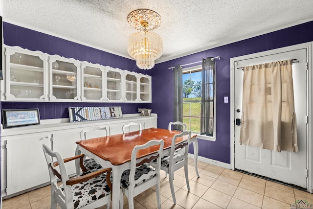 7869 Arrowwood Rd, Gilmer, TX 75644 - dining space with a chandelier, a textured ceiling, light tile patterned flooring, and baseboards