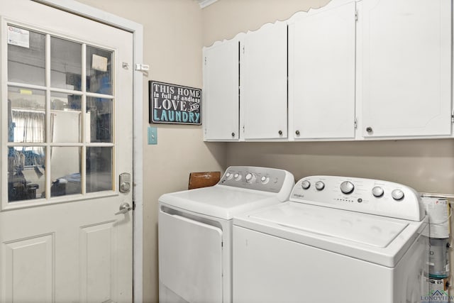 7869 Arrowwood Rd, Gilmer, TX 75644 - laundry room featuring washer and clothes dryer and cabinet space