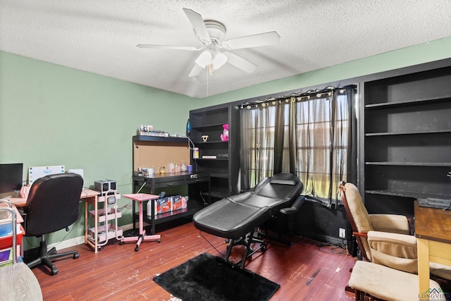 7869 Arrowwood Rd, Gilmer, TX 75644 - home office featuring wood finished floors, a ceiling fan, a textured ceiling, and baseboards