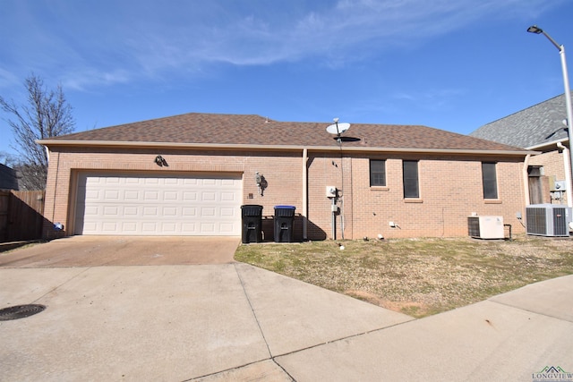 view of side of property featuring a garage and central AC unit