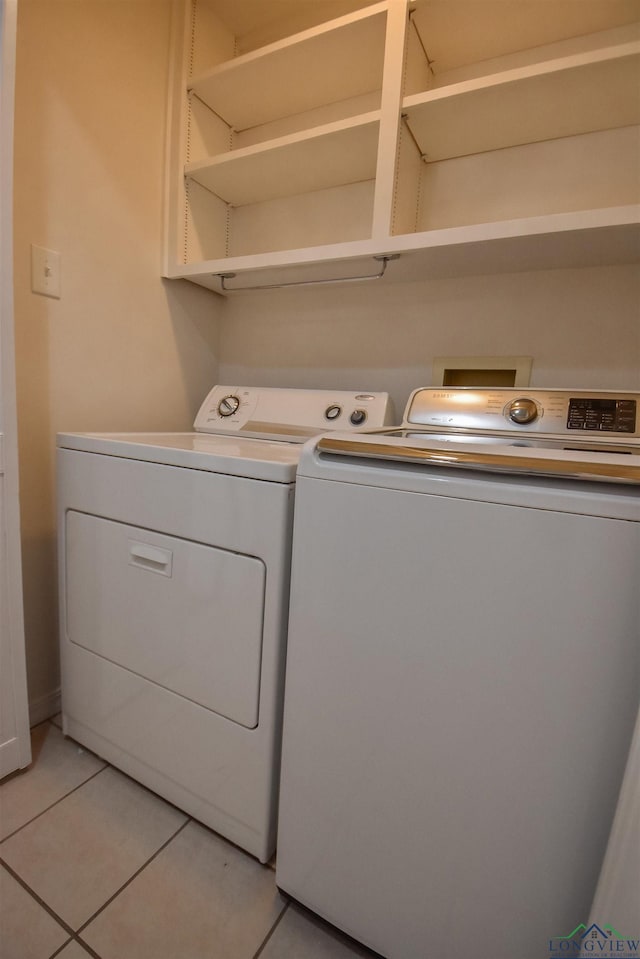 laundry room with light tile patterned floors and separate washer and dryer