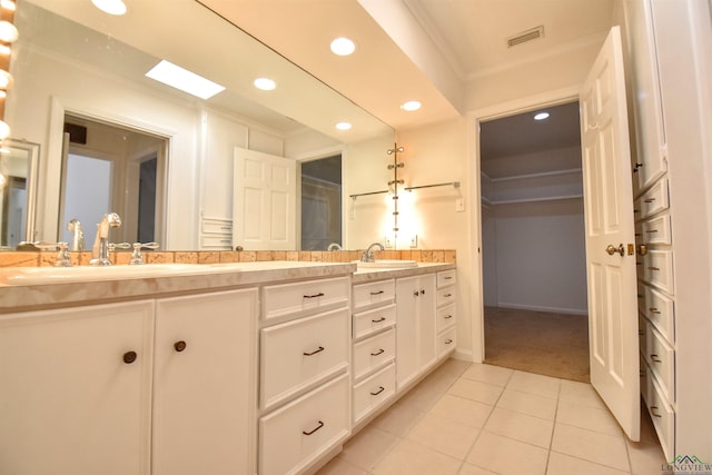 bathroom with tile patterned floors, vanity, and ornamental molding