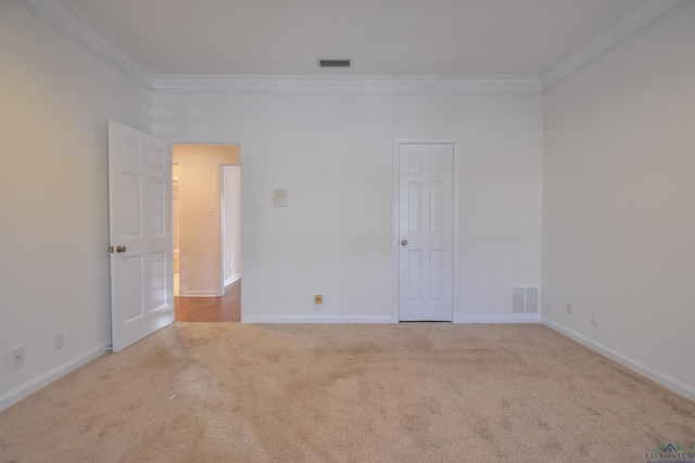 carpeted empty room with crown molding