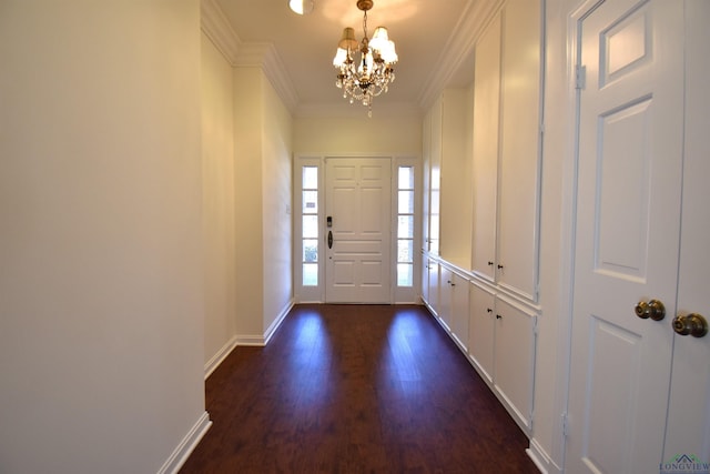 entrance foyer with crown molding, an inviting chandelier, and dark hardwood / wood-style floors