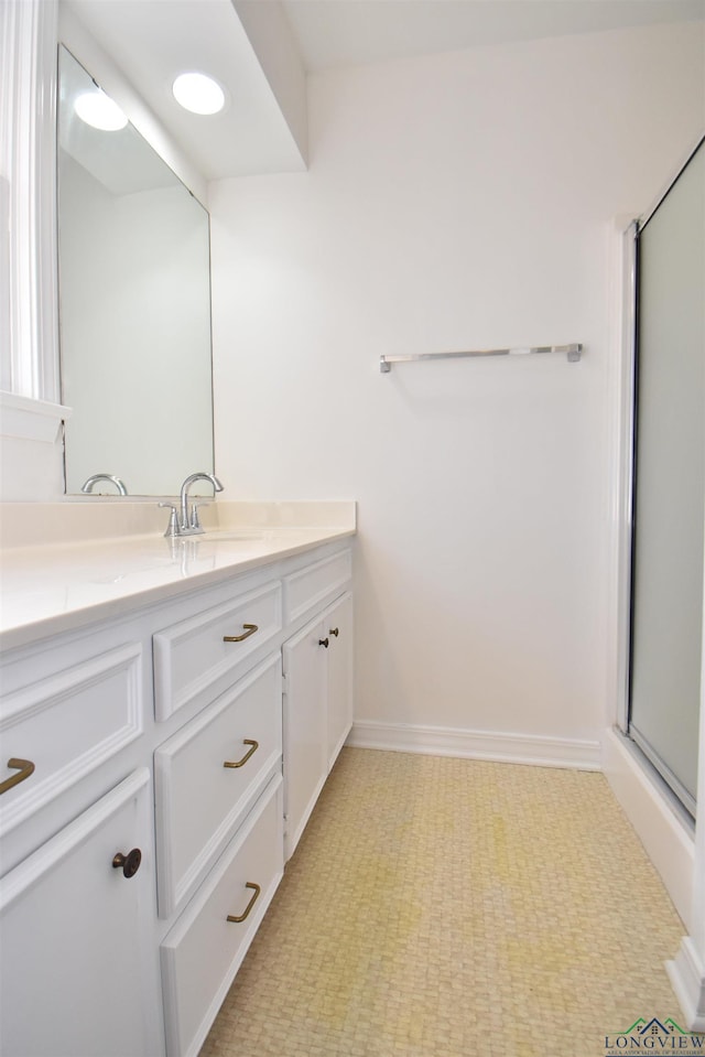 bathroom featuring walk in shower and vanity