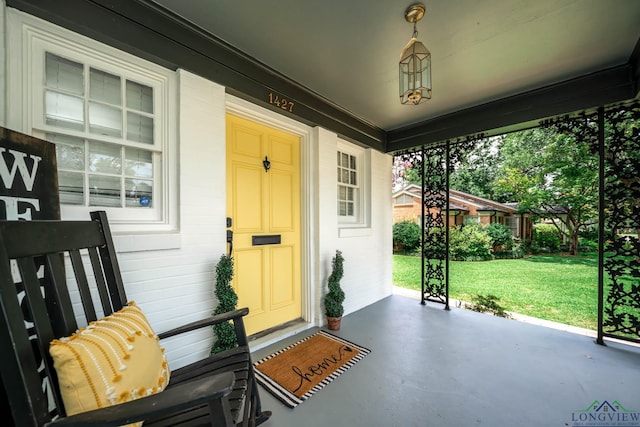1427 S Wall Ave, Tyler, TX 75701 - doorway to property featuring a porch and a lawn