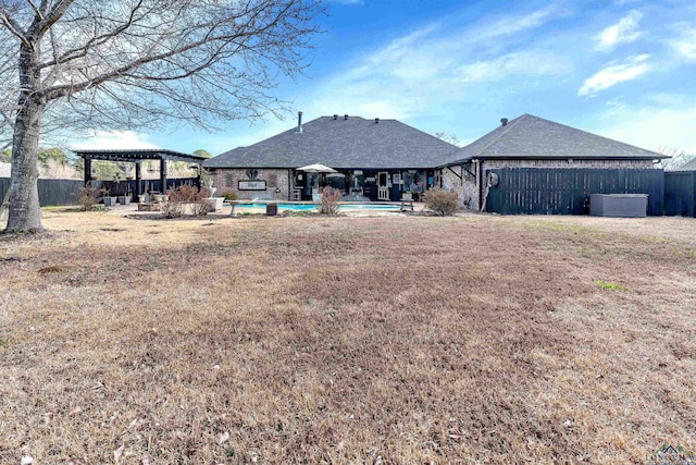 rear view of house with a patio area, fence, a fenced in pool, and a pergola