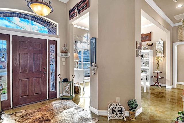 entryway with visible vents, baseboards, crown molding, and recessed lighting