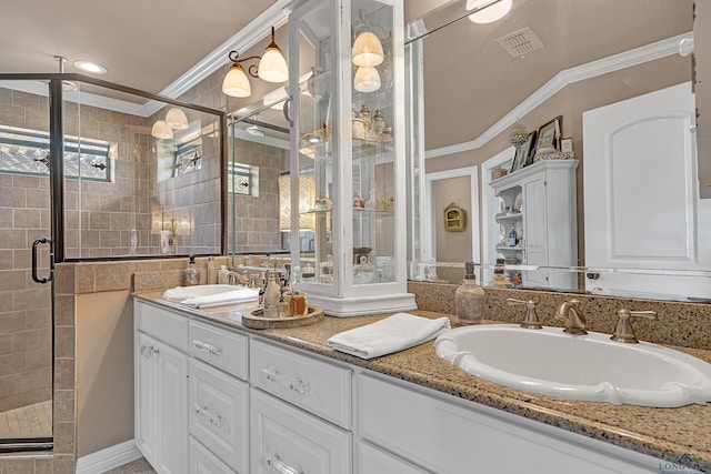 bathroom with ornamental molding, visible vents, and a sink