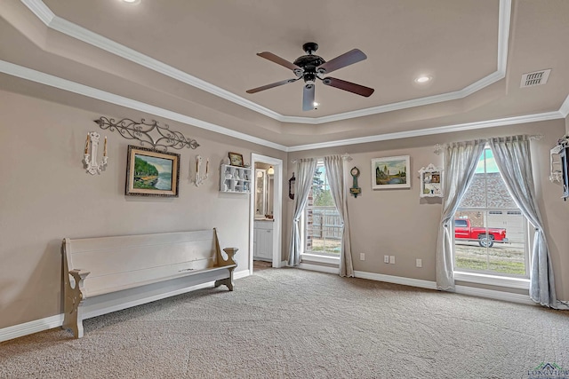 unfurnished room featuring carpet, a tray ceiling, crown molding, visible vents, and baseboards