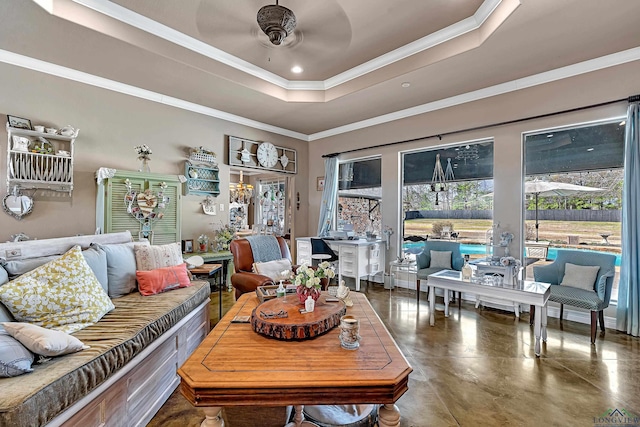 living area featuring finished concrete flooring, a raised ceiling, a ceiling fan, crown molding, and recessed lighting