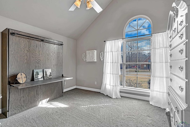 interior space with high vaulted ceiling, carpet, ceiling fan, and baseboards