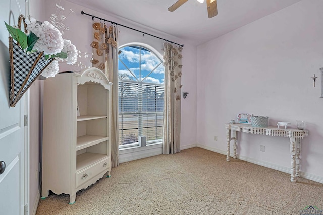 interior space with ceiling fan, baseboards, and carpet flooring