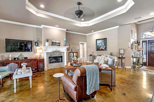 living area with ornamental molding, a raised ceiling, a fireplace, and baseboards