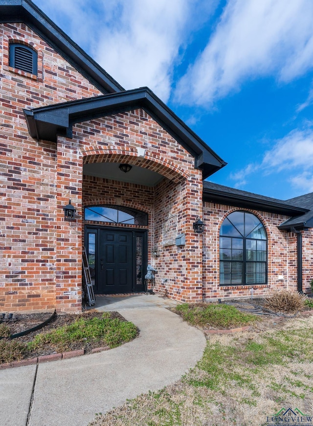 property entrance with brick siding