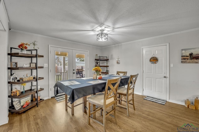 1216 Fm 2468, Center, TX 75935 - dining room featuring french doors, a textured ceiling, light wood-style floors, crown molding, and baseboards