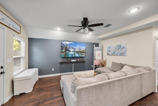 living room with dark hardwood / wood-style flooring and ceiling fan